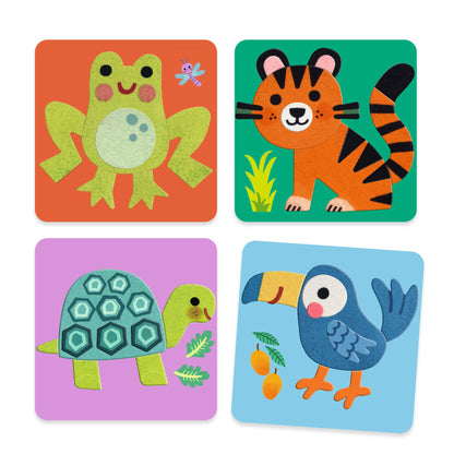 Les quatre tableaux d'animaux terminés en feutrine douce : une grenouille verte, un tigre orange, une tortue et un toucan bleu.