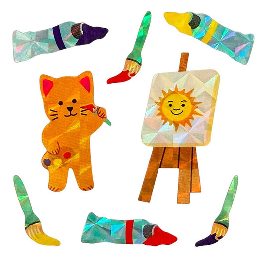 Gros plan sur les autocollants brillants d'un chat peintre avec sa palette, son chevalet affichant un soleil, des pinceaux et tubes de peinture.