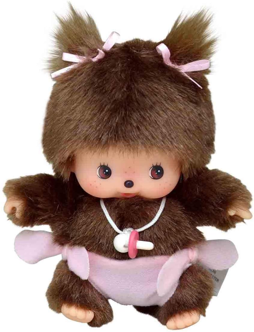 Peluche Bébé Monchhichi de Sekiguchi avec couche rose, tétine autour du cou et deux petites couettes ornées de rubans.