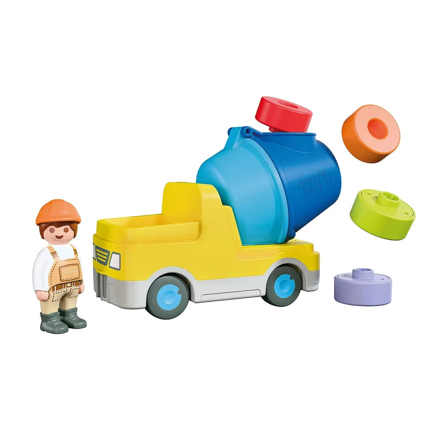 Ensemble de jeu bétonnière Playmobil Junior 72083 avec figurine d'ouvrier de chantier et quatre blocs colorés empilables.