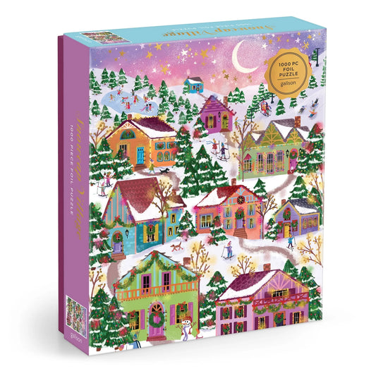 Boîte du casse-tête de 1000 pièces avec détails dorés Snowcap Village Galison, illustrant un village d'hiver enneigé sous un ciel étoilé avec croissant de lune.