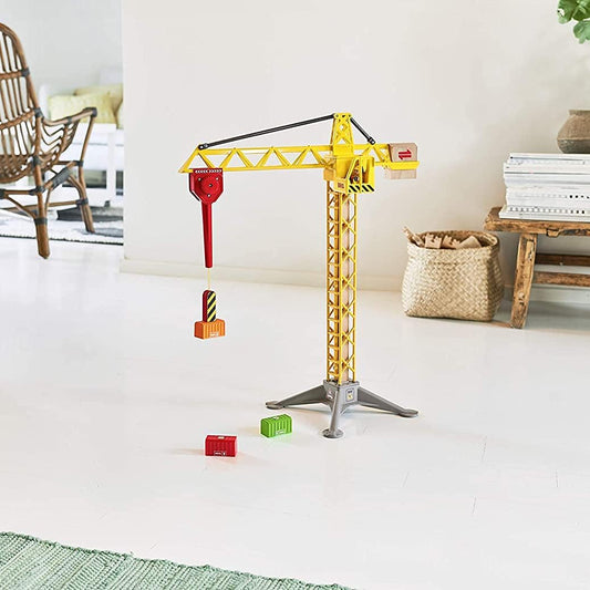 Grande grue lumineuse de chantier BRIO installée dans une pièce de séjour moderne avec ses conteneurs magnétiques au sol.
