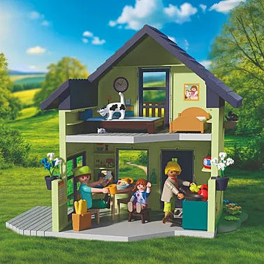 Vue arrière de la maison de la ferme Playmobil Country 72162 montrant l'intérieur aménagé sur deux étages avec la famille et les meubles.