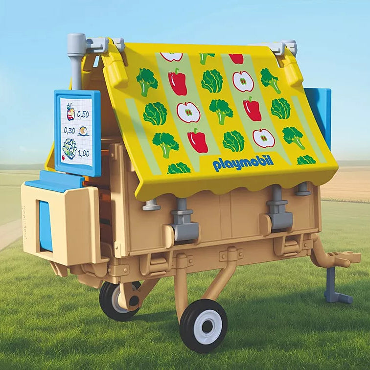  Stand de marché mobile Playmobil Country 72164 replié sous forme de remorque avec son auvent illustré de légumes et ses roues.